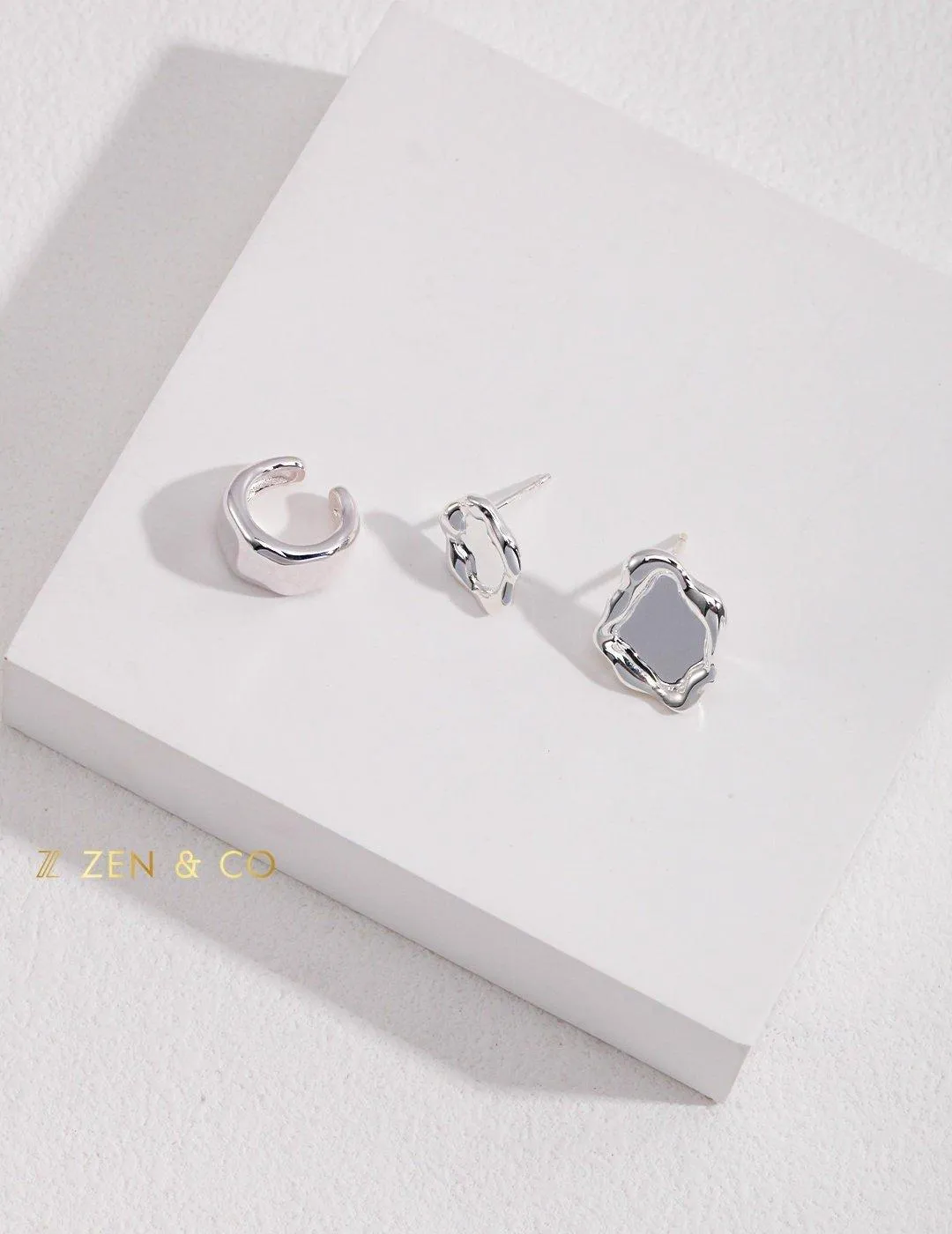 PLACID Asymmetric fluid Way of water stud earrings