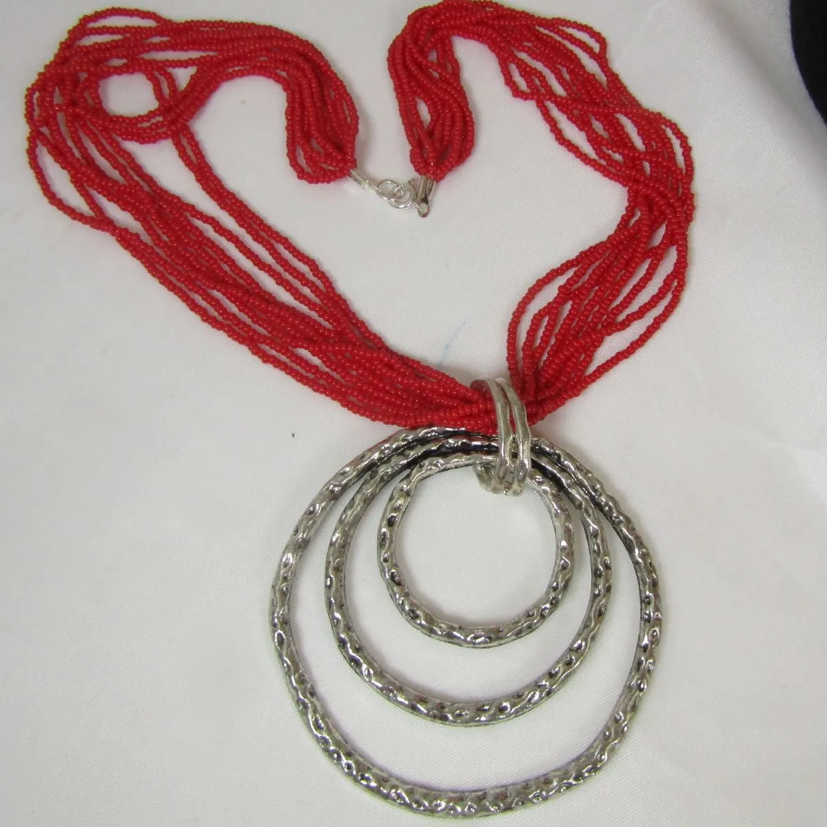 Red Bead Multi-strand Necklace with Hammered Antique Silver Pendant